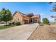 Charming, single-Gathering home with beautiful landscaping and a long driveway leading to the garage at 14805 Quince Way, Thornton, CO 80602