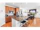 Spacious kitchen island with granite countertops, stainless appliances and adjacent dining area at 14805 Quince Way, Thornton, CO 80602