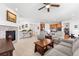 Open concept living area flows into the kitchen, featuring hardwood floors, a fireplace and modern appliances at 14805 Quince Way, Thornton, CO 80602