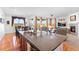 Open-concept living spaces featuring a kitchen island, dining area, and a cozy living room with a fireplace at 14805 Quince Way, Thornton, CO 80602