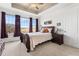Spacious primary bedroom with natural light, trey ceiling, and stylish furnishings at 14805 Quince Way, Thornton, CO 80602