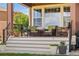 Relaxing outdoor patio with comfortable wicker furniture, potted plants, and a stylish outdoor setting at 14805 Quince Way, Thornton, CO 80602