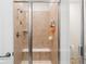 Tiled shower with seating, providing a luxurious and convenient bathing experience in this well-designed bathroom at 14805 Quince Way, Thornton, CO 80602