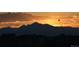 Beautiful sunset view over mountains with construction site below, highlighting the community's location at 14805 Quince Way, Thornton, CO 80602