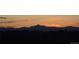 Picturesque sunset view over the mountains from a new development under construction at 14805 Quince Way, Thornton, CO 80602