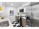 Modern kitchen with stainless steel appliances and a black and white checkered floor at 2400 E 13Th Ave # 1, Denver, CO 80206