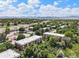 Aerial view of condo complex with mature landscaping and mountain views at 5995 W Hampden Ave # 18C, Denver, CO 80227