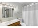Bright bathroom featuring a vanity with solid surface top and tub with shower at 5995 W Hampden Ave # 18C, Denver, CO 80227