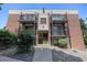 Exterior shot of a three-story brick apartment building with a concrete walkway at 5995 W Hampden Ave # 18C, Denver, CO 80227