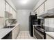 Efficient kitchen with black appliances and ample counter space at 5995 W Hampden Ave # 18C, Denver, CO 80227