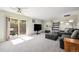 Bright living room featuring sliding glass door and comfortable seating at 5995 W Hampden Ave # 18C, Denver, CO 80227