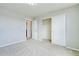 Neutral carpeted bedroom with natural light, a closet, and a door that leads to another room at 10049 Granby Dr, Commerce City, CO 80022