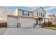 Charming two-story home featuring a three-car garage, landscaped yard, and classic architectural details at 10049 Granby Dr, Commerce City, CO 80022