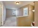Upstairs hallway with carpet flooring, with a doorway leading to another room at 10049 Granby Dr, Commerce City, CO 80022