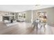Open-concept living and dining area with a fireplace and sliding doors to the backyard at 10049 Granby Dr, Commerce City, CO 80022
