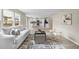 Open-concept living area flowing into a modern kitchen with sleek white cabinets and stainless steel appliances at 10049 Granby Dr, Commerce City, CO 80022