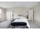 Large bedroom with vaulted ceiling, soft carpet, and a modern black bench at 10049 Granby Dr, Commerce City, CO 80022