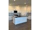 Modern kitchen features white cabinets, black hardware, black countertops and backsplash with center island at 14295 Currant St, Broomfield, CO 80020