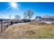 Sloped backyard with shed and partial snow cover at 3446 S Clay St, Englewood, CO 80110