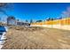 Large backyard, partially covered in dry grass at 3446 S Clay St, Englewood, CO 80110