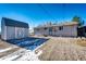 Large backyard with gravel, shed, and partial snow cover at 3446 S Clay St, Englewood, CO 80110