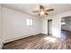 Bright bedroom featuring wood-look floors and ample closet space at 3446 S Clay St, Englewood, CO 80110