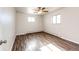 Spacious bedroom with wood-look flooring and ceiling fan at 3446 S Clay St, Englewood, CO 80110