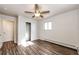 Spacious bedroom with wood-look floors, ceiling fan, and closet at 3446 S Clay St, Englewood, CO 80110
