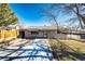 Front view of a charming ranch home with a fenced yard at 3446 S Clay St, Englewood, CO 80110