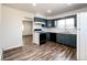 Efficient kitchen featuring teal cabinets and a spacious layout at 3446 S Clay St, Englewood, CO 80110