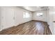 Spacious living area with wood-look floors and an interior door at 3446 S Clay St, Englewood, CO 80110
