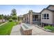 Beautiful backyard with patio, fire pit, and nicely landscaped area at 13087 W 27Th Ln, Golden, CO 80401