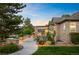 Well-maintained backyard featuring a covered patio, fire pit, and lush greenery at 13087 W 27Th Ln, Golden, CO 80401