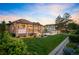 Expansive backyard featuring a covered patio, fire pit, multi-car garage and a well-maintained lawn at 13087 W 27Th Ln, Golden, CO 80401