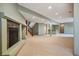Finished basement area featuring a cozy fireplace and stairs to the upper level at 13087 W 27Th Ln, Golden, CO 80401