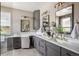 Bright bathroom featuring dual sinks, stylish vanities, modern lighting fixtures, and makeup station at 13087 W 27Th Ln, Golden, CO 80401