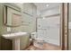 Finished basement bathroom features tiled shower and modern pedestal sink at 13087 W 27Th Ln, Golden, CO 80401