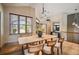 Bright dining room showcasing wood floors, table with chairs, and a large window allowing ample natural light at 13087 W 27Th Ln, Golden, CO 80401