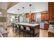 Modern kitchen with a large island, stainless steel appliances, stylish lighting, and a view to the outdoor patio at 13087 W 27Th Ln, Golden, CO 80401