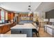 Spacious kitchen with large center island, custom cabinetry, stainless steel appliances, and modern lighting at 13087 W 27Th Ln, Golden, CO 80401