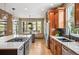 Well-lit kitchen featuring a large island, stainless steel appliances, custom cabinetry, and hardwood floors at 13087 W 27Th Ln, Golden, CO 80401