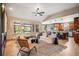 Inviting living room with vaulted ceilings, large windows, modern furniture, and open layout to the kitchen at 13087 W 27Th Ln, Golden, CO 80401