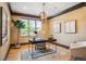 Cozy home office with modern chandelier and warm, natural light at 13087 W 27Th Ln, Golden, CO 80401