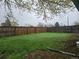 Spacious backyard with lush green grass and a wooden fence offers privacy at 795 Vivian Ct, Lakewood, CO 80401