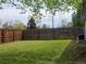 Spacious backyard with a large, well-maintained lawn area and a wooden privacy fence, creating a perfect outdoor retreat at 795 Vivian Ct, Lakewood, CO 80401