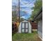 Backyard gray shed for extra storage, nestled in a grassy yard with a wooden fence and blue sky at 795 Vivian Ct, Lakewood, CO 80401