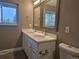Well-lit bathroom with double sinks, decorative mirrors, and modern fixtures create an inviting space at 795 Vivian Ct, Lakewood, CO 80401