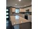 Modern kitchen features a quartz countertop island, stainless steel appliances and elegant tiled backsplash at 795 Vivian Ct, Lakewood, CO 80401
