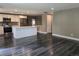 Open-concept space with sleek, hardwood floors, connecting the living area to a modern kitchen with a central island at 795 Vivian Ct, Lakewood, CO 80401