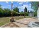 Spacious backyard with string lights, shed, patio, and mature trees offers outdoor living space at 765 Iola St, Aurora, CO 80010